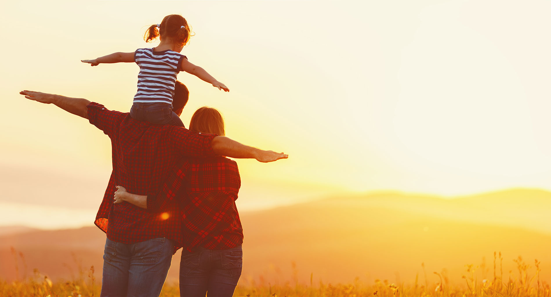 A mother, father, and little girl with outstretched arms