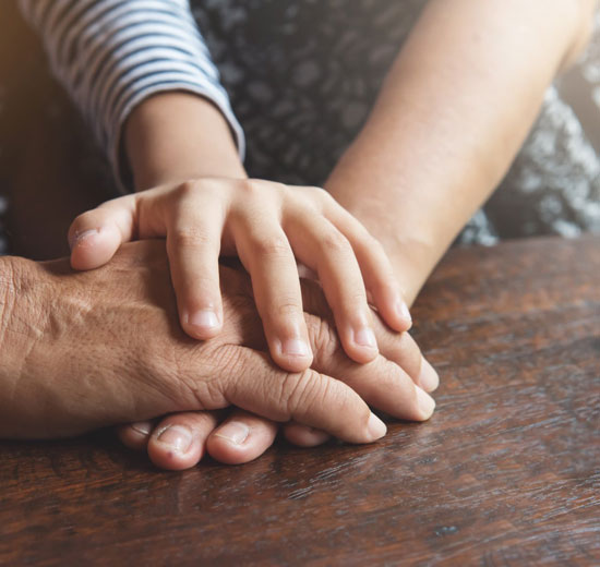 A close up of two people holding hands