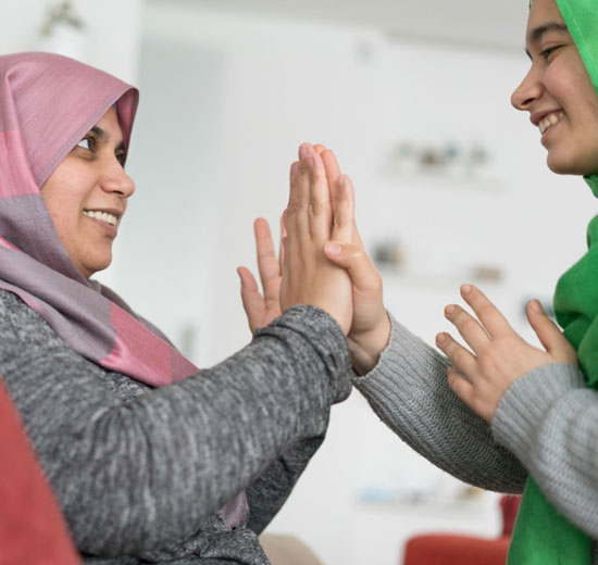 Two young immigrant women laughing together